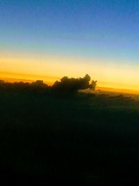 Scenic view of silhouette field against clear sky