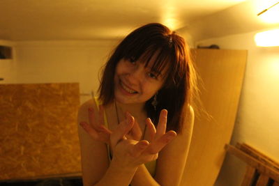 Portrait of a smiling young woman at home