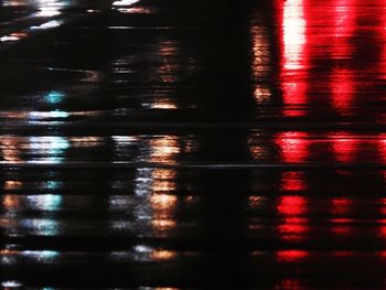 Reflection of illuminated puddle in water