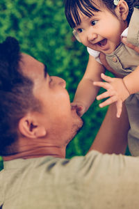 Young father and his adorable baby daughter bonding together enjoying their relationship.