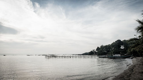 Scenic view of sea against cloudy sky