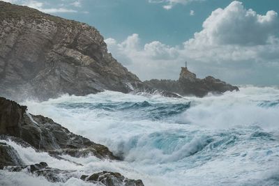 Scenic view of waves breaking on rocks