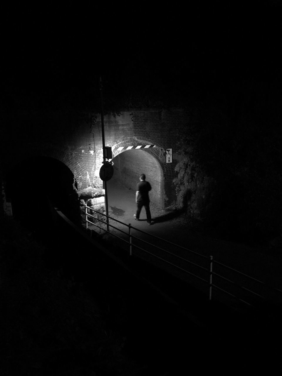 full length, lifestyles, walking, men, rear view, leisure activity, railing, the way forward, transportation, silhouette, person, connection, street light, on the move, bridge - man made structure, standing, road