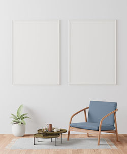 Empty chairs and table against wall at home