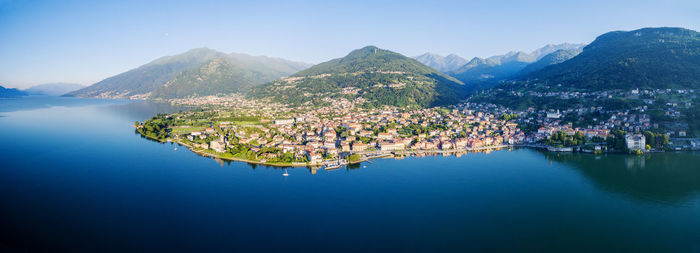 Aerial view of town by sea against sky