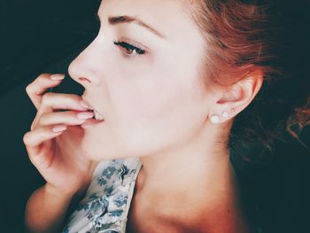 Close-up portrait of young woman looking away