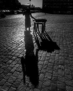 Shadow of woman on footpath