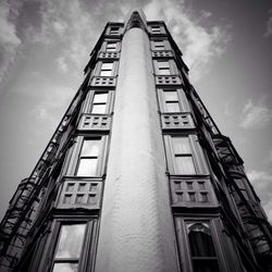 Low angle view of building against cloudy sky