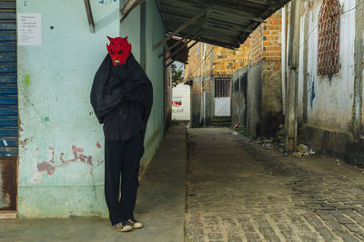 Full length of man in spooky costume standing on street