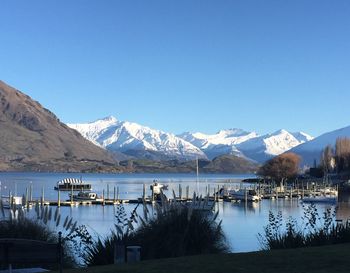 Scenic view of snowcapped mountains against clear blue sky