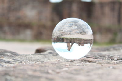 Close-up of crystal ball on glass