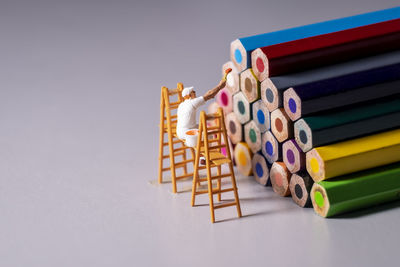 Close-up of multi colored pencils against white background