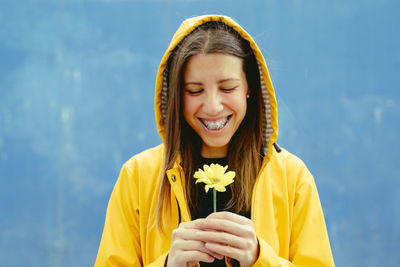 Portrait of young woman holding flower