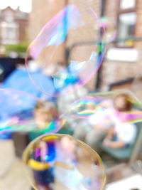 Close-up of colorful bubbles against blue sky