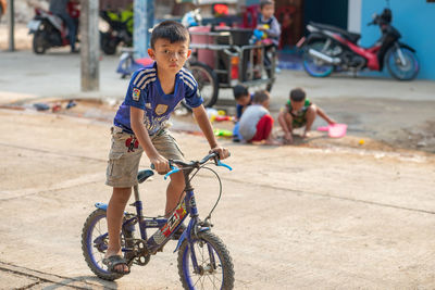 Boy riding bicycle on road