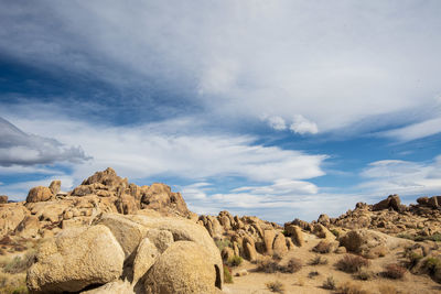 Rock formations on landscape against sky