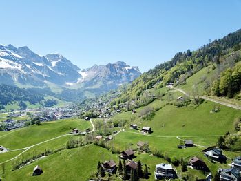 Scenic view of landscape and mountains against clear sky