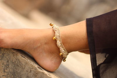Close-up of woman wearing anklet