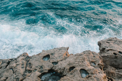 Waves splashing on rocks at shore