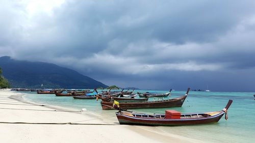 Boats moored on sea against sky