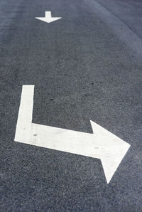 High angle view of arrow sign on road