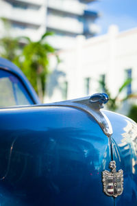Close-up of blue car in city