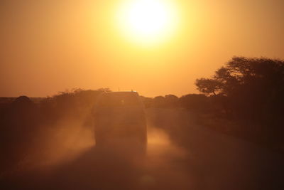 Scenic view of silhouette landscape against orange sky