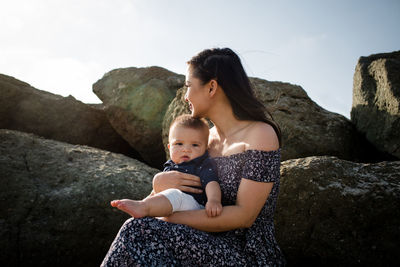 Mother and son on rock