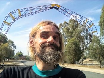 Portrait of smiling man against sky