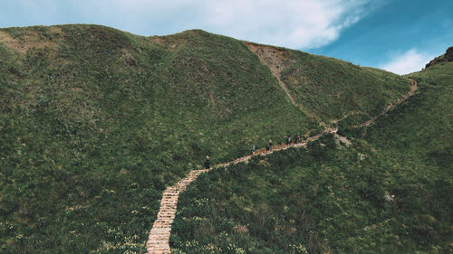 Scenic view of land and mountains against sky