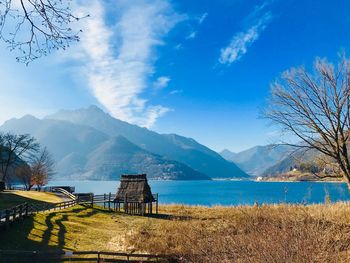 Scenic view of lake by mountains against sky