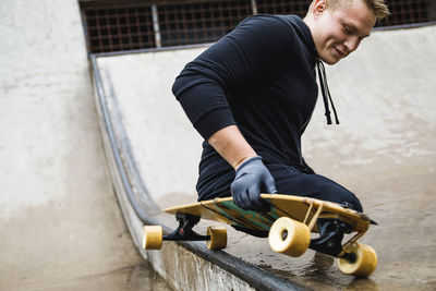 Disabled man skateboarding at park