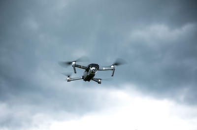 Low angle view of airplane flying against sky