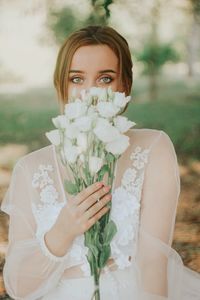 Portrait of bride holding white flowers