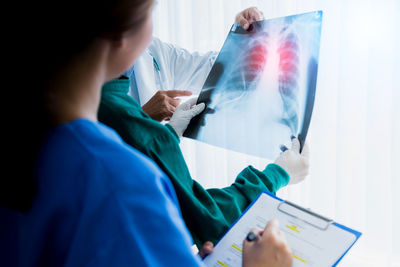 Healthcare workers discussing over medical x-ray in hospital