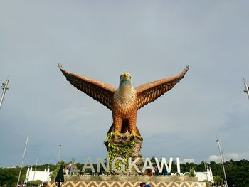 Low angle view of statue against sky