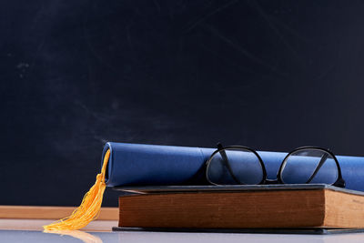 Close-up of books on table against black background