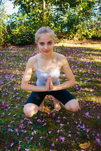 Portrait of beautiful young woman practicing yoga at park