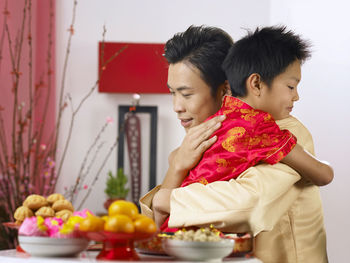 Father embracing son during festival