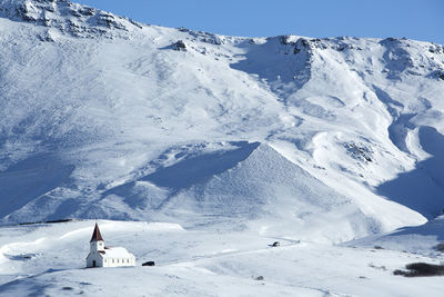 Church of vik in wintertime with snowy mountains, iceland