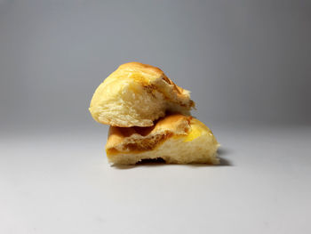 Close-up of burger against white background