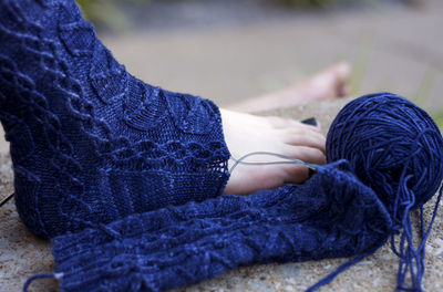 Low section of woman wearing blue wool sock