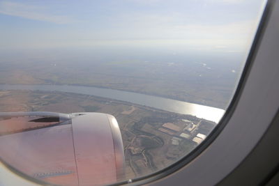 Aerial view of landscape seen through airplane window