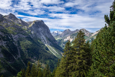 Scenic view of mountains against cloudy sky