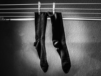 Socks drying on clothesline against wall