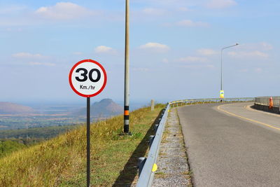 Road sign against sky