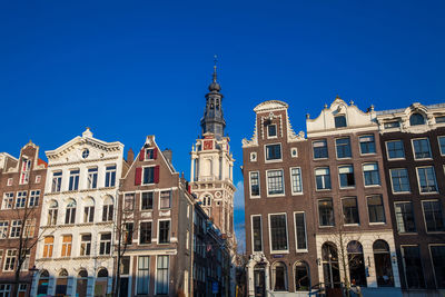 Low angle view of buildings against blue sky