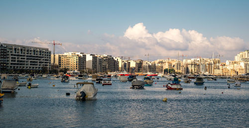 Panoramic view of sea and buildings against sky