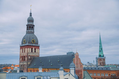 Tower amidst buildings in city against sky