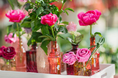 Fresh and decorative artificial roses in vases